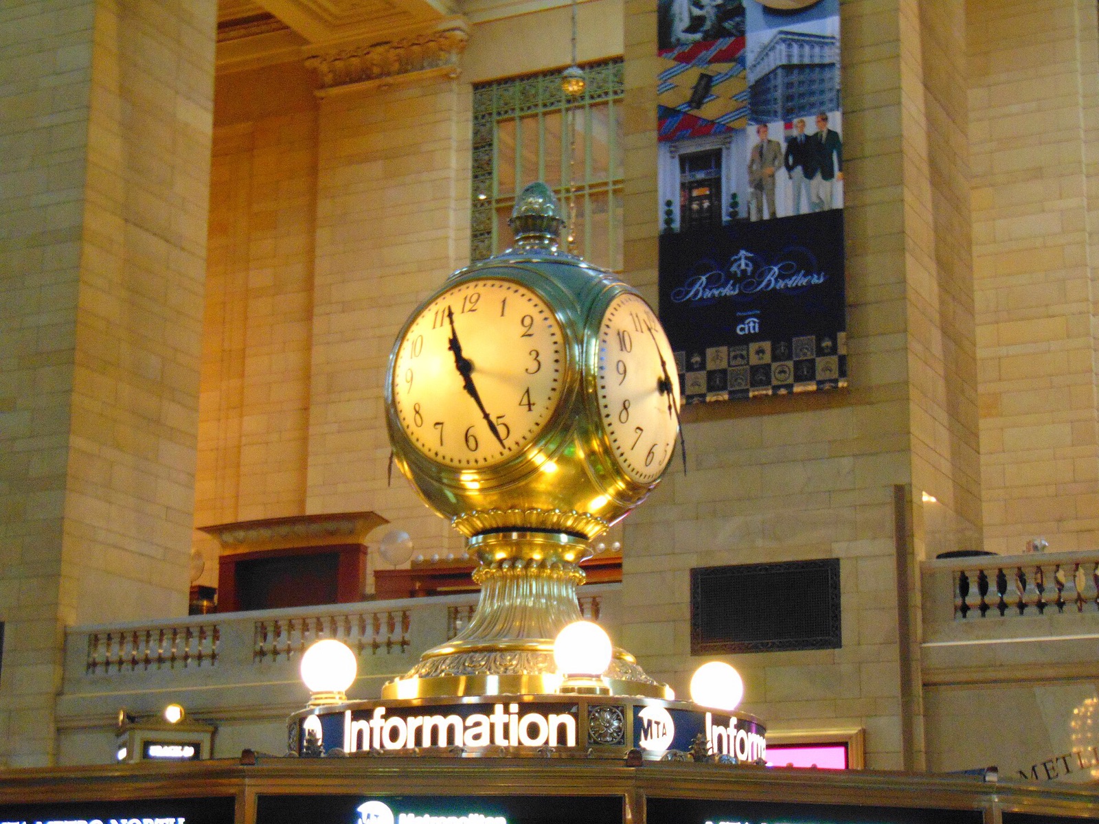 The brass clock with four faces on top of the information booth in Grand Central Terminal.