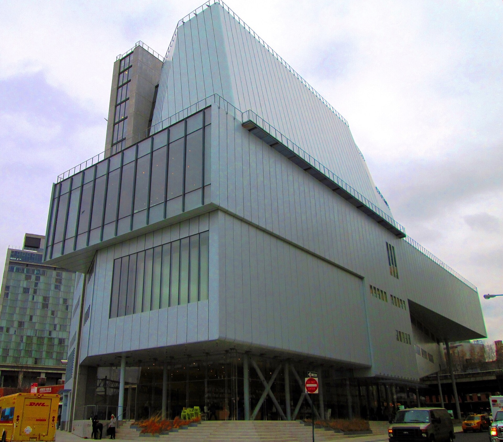 The Whitney Museum from the west, a tall asymmetrical building clad in pale steel panels.