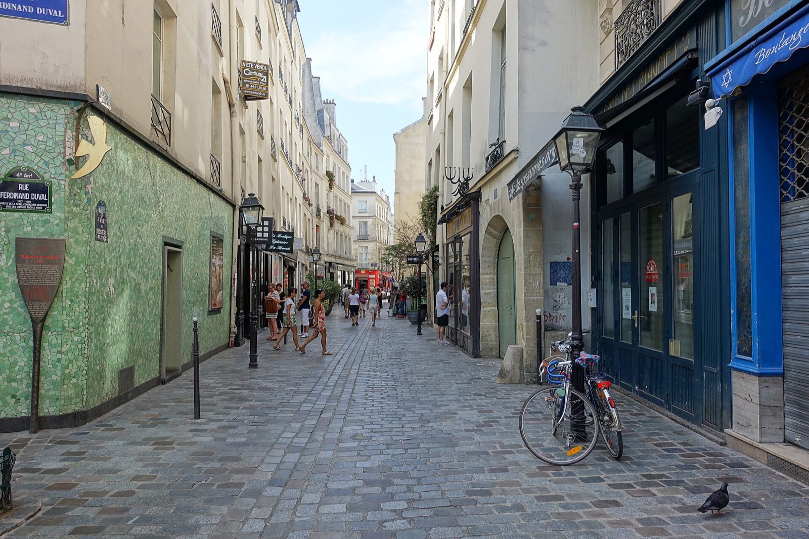 The rue des Rosiers in the old Jewish quarter of Le Marais, a narrow street of shop fronts.