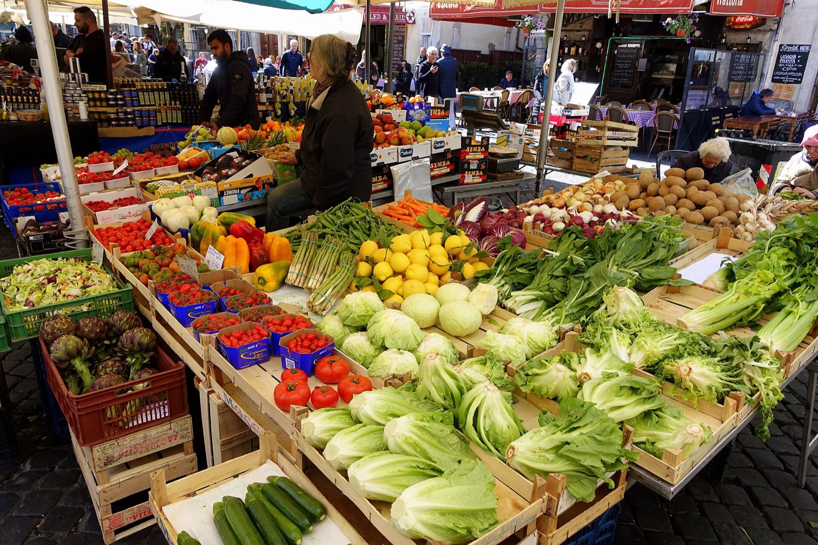 A stall piled with vegetables at the market of Campo de' Fiori.