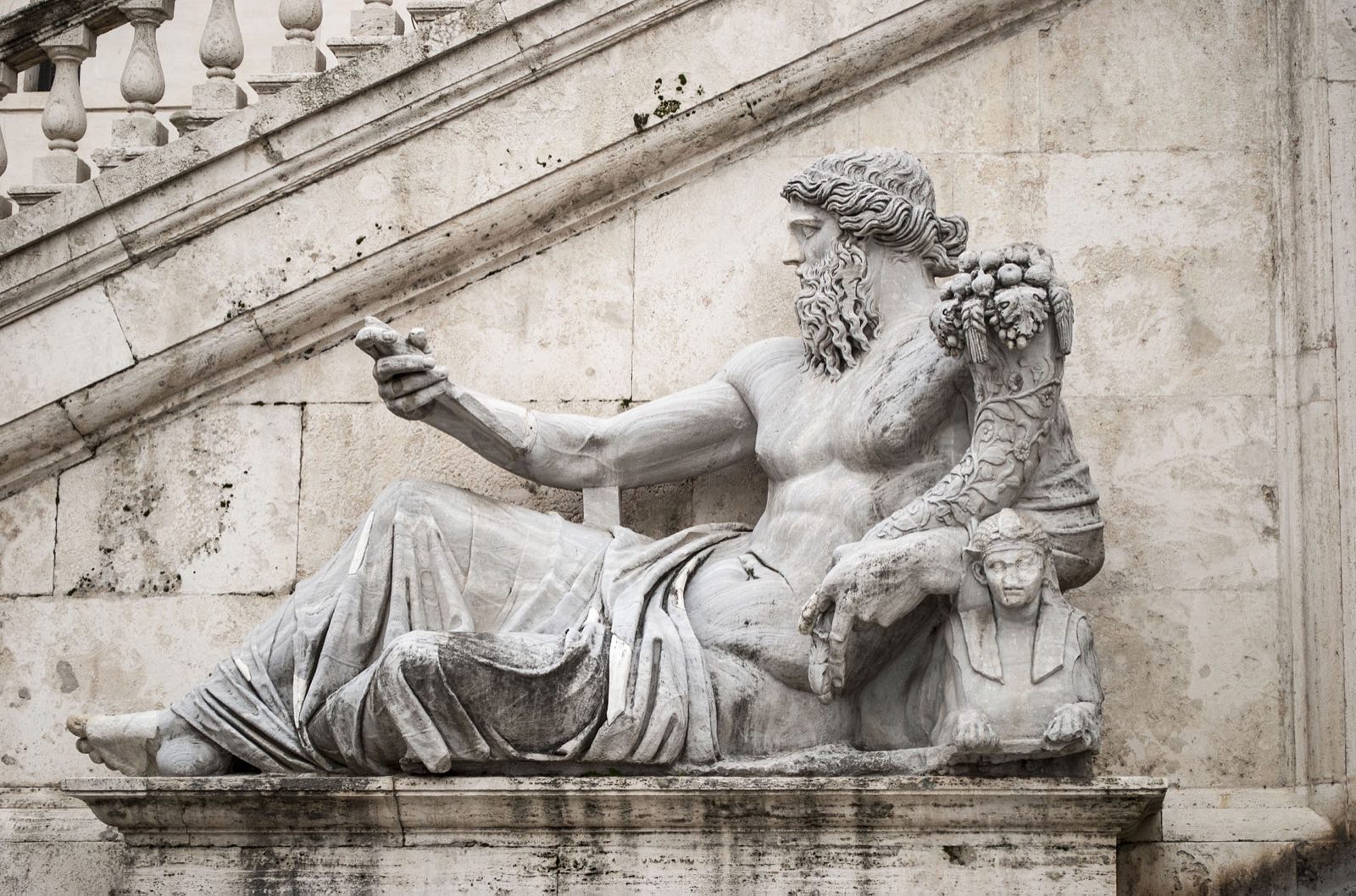 A reclining marble river god, the Nile, in the fountain on the Piazza del Campidoglio.