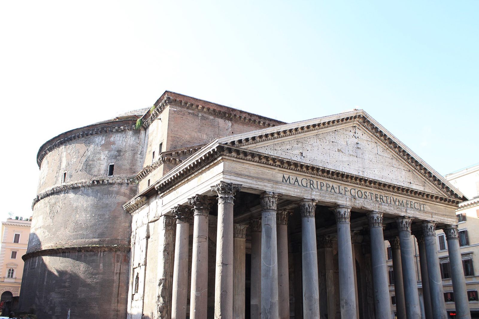 The porch and the round brick drum of the Pantheon seen from the side.