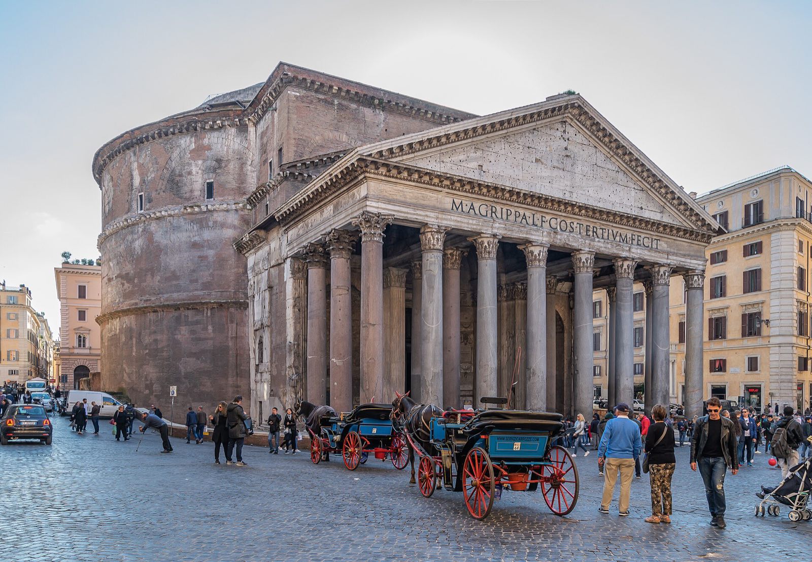 The Pantheon and its porch of granite columns, with a horse carriage waiting in the square in front.