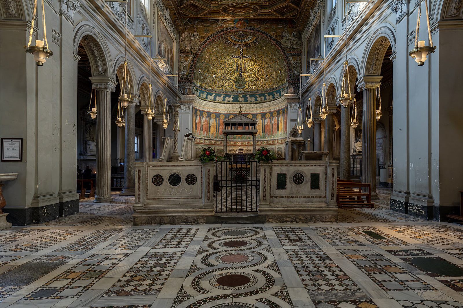 The nave of San Clemente, with its marble choir, patterned floor and gilded ceiling.